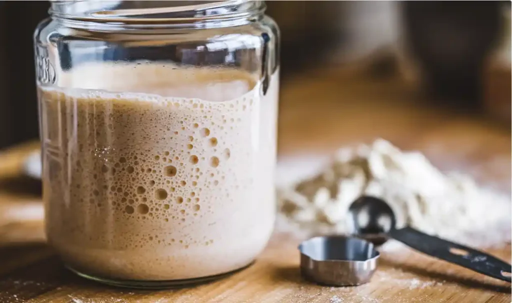 Bubbles forming in a sourdough starter jar